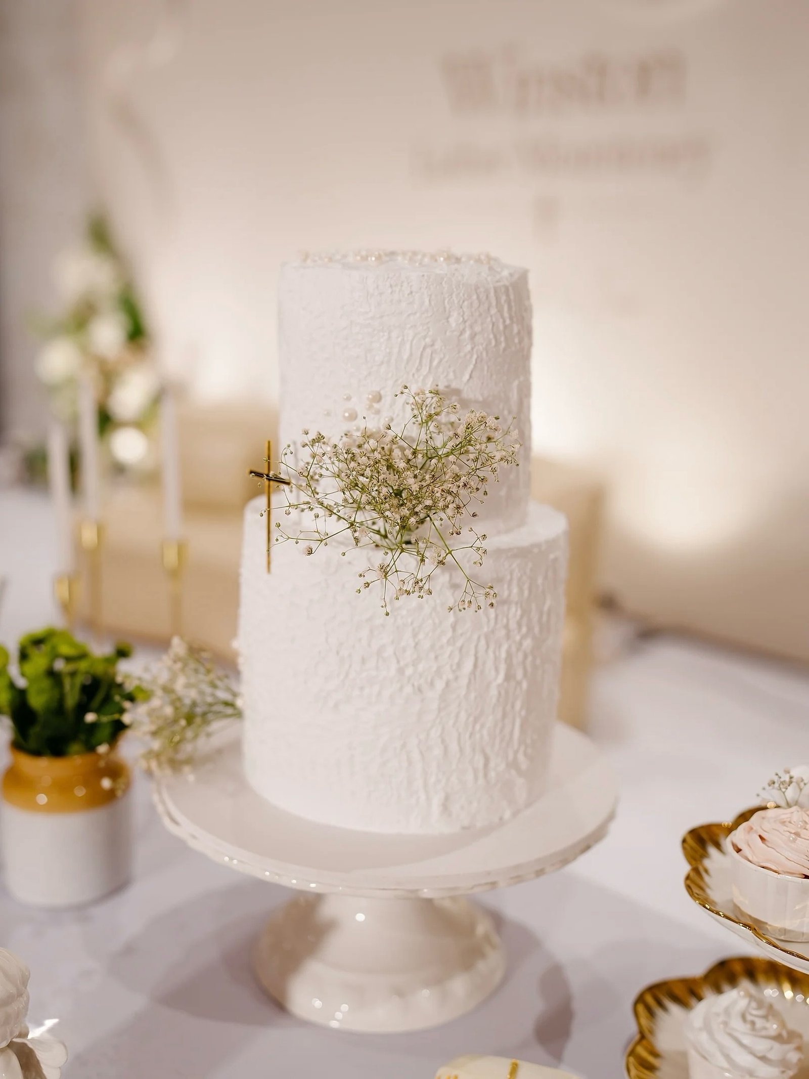 Minimal white celebration cake with baby's breath flowers